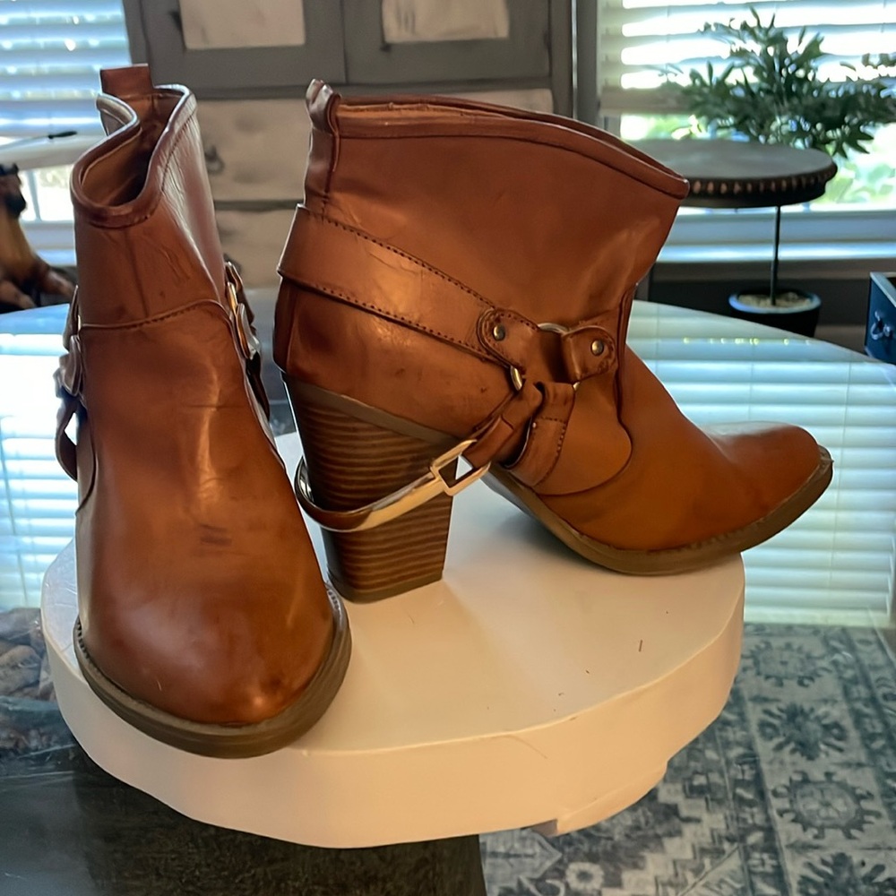 Brown cowboy style short boots…not sure if the leather is real or fake